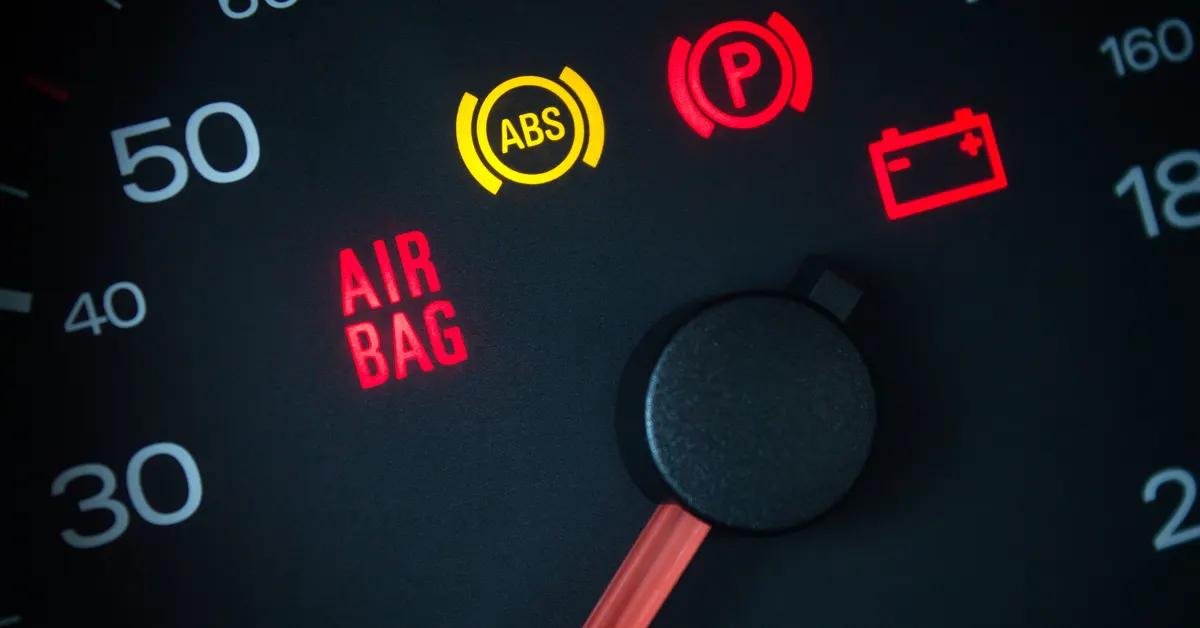 Close up of the warning symbols on a car dashboard.
