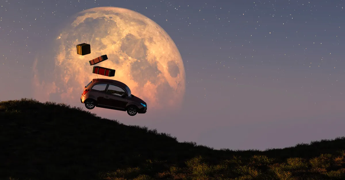A black silhouette of a small car suspended in the air, hovering over a rolling, grassy hill. The sky is a gradient of dusky pink and dark orange, transitioning into a deep blue speckled with stars.